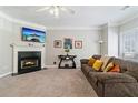 Living room with fireplace, brown couch, and carpet flooring at 1968 Drennon Ave, Austell, GA 30106