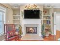 Living room fireplace with built-in shelving and hardwood floors at 3275 Lenox Ne Rd # 206, Atlanta, GA 30324