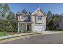 Two-story house with gray siding, white garage door, and landscaping at 820 River Gardens Se Dr, Atlanta, GA 30354