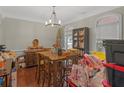 Simple dining room with wooden table and a chandelier at 10 Toscanno Dr, Covington, GA 30014