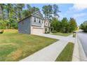 Side view of two-story home showcasing gray siding, stone accents, and a spacious lawn at 2570 Reynolds Sw Rd, Atlanta, GA 30331