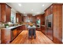 Well-equipped kitchen with wooden cabinetry, granite countertops, and stainless steel appliances at 2656 Old Norcross Rd, Tucker, GA 30084