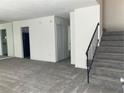 Living room with gray carpet, stairs, and access to other rooms at 6354 Shannon Pkwy # 6D, Union City, GA 30291