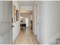 Light and bright entryway with luxury vinyl plank flooring and view to the living area at 746 River Gardens Se Dr, Atlanta, GA 30354