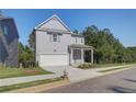 Two-story Craftsman style home with gray siding, white trim, and a two-car garage at 746 River Gardens Se Dr, Atlanta, GA 30354