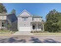 Two-story Craftsman style home with gray siding, white trim, and a two-car garage at 746 River Gardens Se Dr, Atlanta, GA 30354