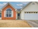 Front entrance with brick facade and storm door at 990 Avalon Dr, Lawrenceville, GA 30044