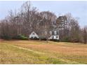 Two-story white house with a green roof, situated on a spacious lot at 105 Pine Valley Rd, Hiram, GA 30141