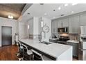 Modern kitchen featuring gray cabinets, quartz countertops, and stainless steel appliances at 855 Peachtree Ne St # 2911, Atlanta, GA 30308