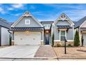 Charming single-Gathering home with gray siding, brick accents, manicured lawn, and a two-car garage at 2540 Village Park Dr, Cumming, GA 30041