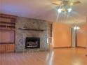 Living room with stone fireplace and built-in shelving at 5078 Hubert Dr, Powder Springs, GA 30127