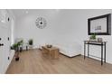 Bright living room with vaulted ceilings, wood floors, white furniture, and minimalist decor at 2019 Arlington Nw Cir, Atlanta, GA 30318