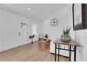 Bright living room with vaulted ceilings, wood floors, white furniture, and minimalist decor at 2019 Arlington Nw Cir, Atlanta, GA 30318