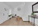 Bright living room with vaulted ceilings, wood floors, white furniture, and minimalist decor at 2019 Arlington Nw Cir, Atlanta, GA 30318