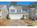 Two-story house with a white exterior, two-car garage, and front yard at 4260 Wesley Hall Dr, Decatur, GA 30035