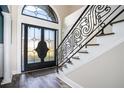 Elegant entryway with double doors, a grand staircase, and intricate railing at 7519 Waterview Cv, Douglasville, GA 30135