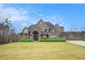 Two-story home with stone and brick exterior, and a manicured lawn at 7519 Waterview Cv, Douglasville, GA 30135