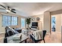 Bright living room with sectional sofa, balcony access, and hardwood floors at 300 W Peachtree St # 12A, Atlanta, GA 30308