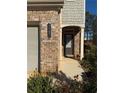 Brick front entrance with a dark gray door and landscaping at 3109 Baylor Cir, Mcdonough, GA 30253
