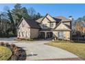 Brick house with stone accents and a curved driveway, surrounded by trees at 5195 Hamby Rd, Acworth, GA 30102