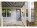 Gray front door entry with covered porch and ramp at 3960 Riverlook Pkwy # 101, Marietta, GA 30067