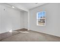 White bedroom has neutral carpet and a window to let in natural light at 4770 Marco Ln, Cumming, GA 30028
