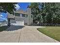 Two-car garage with driveway and fenced backyard at 6425 Riley Manor Way, Cumming, GA 30028