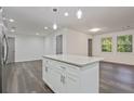 White kitchen island with granite countertop and white shaker cabinets at 8658 Knox Bridge Hwy, Canton, GA 30114