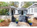 Inviting front porch with stone details, steps, and landscaping at 1252 Mclendon Ne Ave, Atlanta, GA 30307