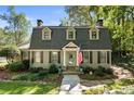 Gray gambrel style house with teal door and American flag at 315 Brandenburgh Cir, Roswell, GA 30075