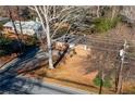 House sits on a large lot with mature trees and road frontage at 3542 N Druid Hill Rd, Decatur, GA 30033