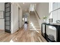 Hardwood floor entryway with staircase and black French doors at 1103 Church Nw St, Atlanta, GA 30318