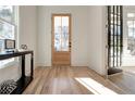 Bright entryway with hardwood floors, light wood door and black French doors at 1103 Church Nw St, Atlanta, GA 30318