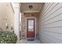 Inviting front door entry with stone accents and a red door at 2411 Oakleaf Cir, Lithonia, GA 30058