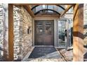 Condo building entrance featuring decorative doors and stonework at 1214 Highland Bluff Se Dr # 214, Atlanta, GA 30339