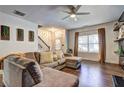 Spacious living room with L-shaped sectional sofa and large windows at 4233 Creekrun Cir, Buford, GA 30519