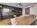 Living room features a fireplace, built-in shelves, and a large sectional sofa at 4233 Creekrun Cir, Buford, GA 30519