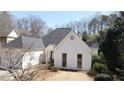 Charming single-Gathering home with white brick exterior and mature trees at 620 Oakledge Nw Dr, Marietta, GA 30060