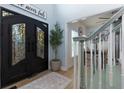 Bright and airy entryway with black double doors and a view of the staircase at 4492 Bryten Dr, Douglasville, GA 30135
