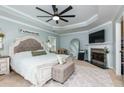 Tranquil main bedroom with a fireplace, tray ceiling, neutral tones, and ample natural light at 4492 Bryten Dr, Douglasville, GA 30135