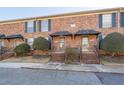 Brick townhouse exterior with landscaping and a walkway at 5667 Kingsport Dr, Atlanta, GA 30342