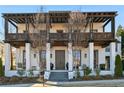 Stunning two-story home with a white exterior, large front porch, and dark brown accents at 6870 Colfax Ave, Cumming, GA 30040