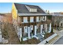 Two-story white home with dark brown accents, balconies, and a covered porch at 6870 Colfax Ave, Cumming, GA 30040