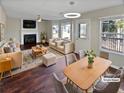 Bright living room with a fireplace, complemented by comfortable furnishings, and ample natural light from large windows at 1043 Carriage Trace Cir, Stone Mountain, GA 30087
