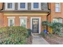 Brick townhouse with front door and landscaping at 3495 Tulip Tree Ln, Duluth, GA 30096