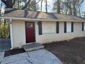 Brick ranch house with a red front door and black shutters at 3705 Daisy Dr, Decatur, GA 30032