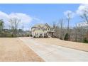 Long driveway leading to a two-story house at 609 River Hl, Mcdonough, GA 30252