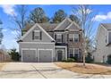 Attractive home featuring a two-car garage, well-maintained lawn, and a welcoming entrance at 2417 Kingston Heath Way, Marietta, GA 30008