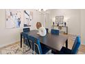 Elegant dining room featuring a dark wood table and blue velvet chairs at 3103 Steinbeck Way, East Point, GA 30344