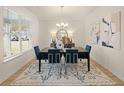 Bright dining room with a table for six and large windows at 3103 Steinbeck Way, East Point, GA 30344